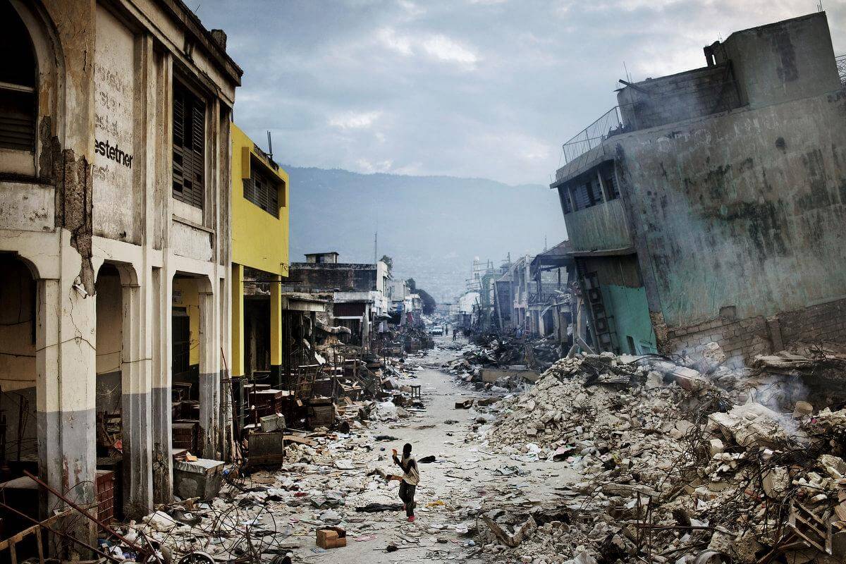 STORY: The January 12 earthquake in Haiti had catastrophic consequences, as it struck the most populated area in the country. The number of casualties rapidly rose to more than 200,000 people, and at least one million Haitians lost their homes. Structures of all kinds collapsed, from shantytowns to national landmarks. A year after the disaster the majority still lives in primitive tent camps around the city. In the weeks following the disaster sporadic violence, looting and gang-related gunfire broke out in downtown Port-au-Prince. The earthquake in Haiti could hardly have struck a worse place on the planet - the most basic necessities like water, food, electricity, communications, transportation and health care that is needed after a quake, were already inadequate before the quake hit. It has created a massive humanitarian crisis in the country routinely referred to as the poorest in the Western hemisphere. THIS IMAGE: A young boy escapes the violence that grew amid desperate looters, as gang-related gunfire broke out in downtown Port-au-Prince.